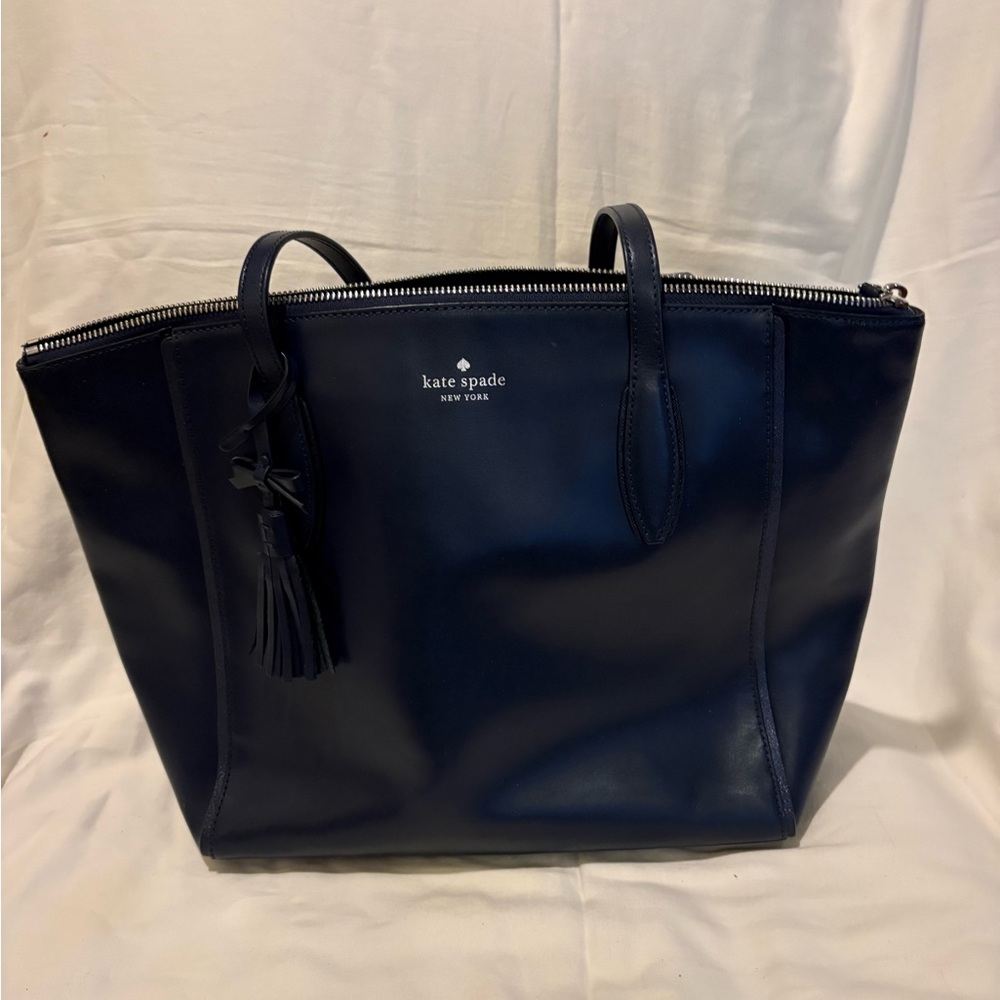 kate spade navy leather tote with tassel charm and navy and white stripe wallet.
